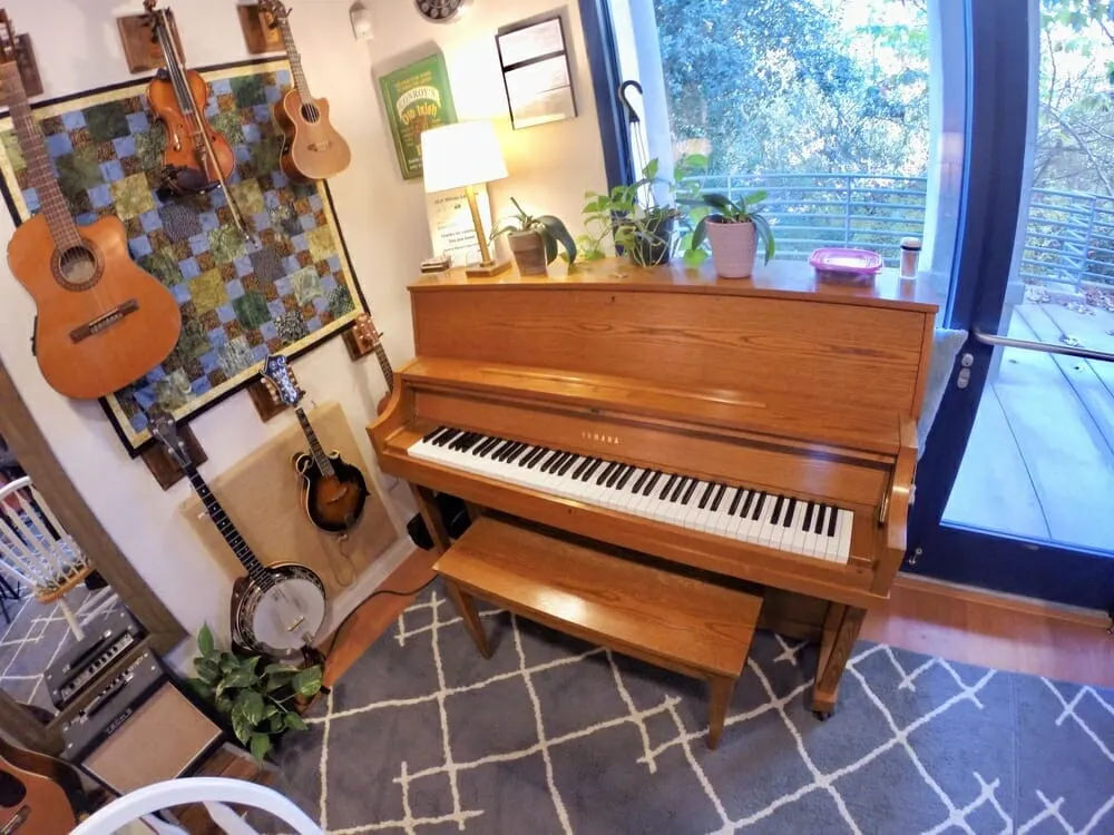 Studio with upright piano and banjos